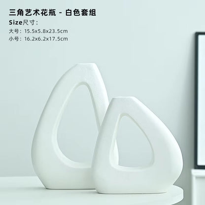 Two white ceramic vases on a light gray background with text displaying dimensions.