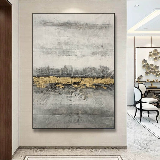 Abstract art painting with gold and gray tones in a modern interior setting.