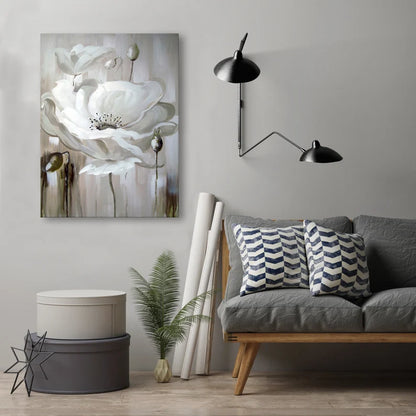 Modern living room with a gray sofa, decorative pillows, a wall lamp, and a floral painting.
