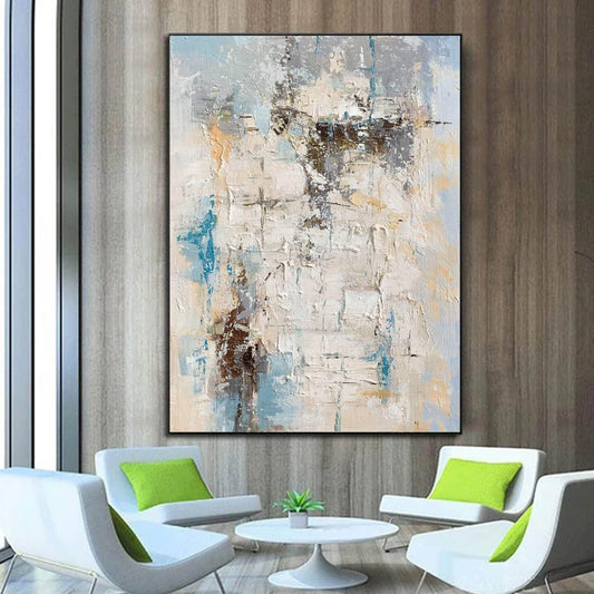 Abstract painting on a wall above modern white furniture with green cushions.