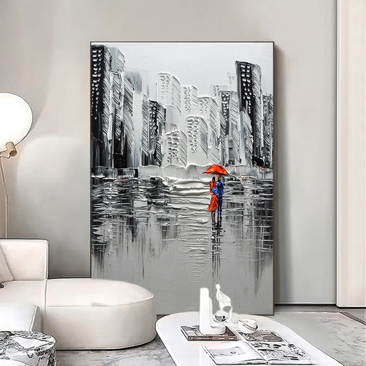 Cityscape painting with a couple holding an umbrella in a modern living room.