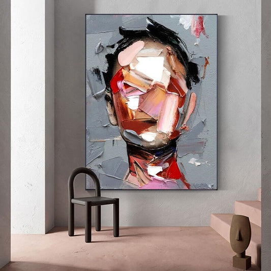 Abstract painting on a wall with a chair and table in the foreground