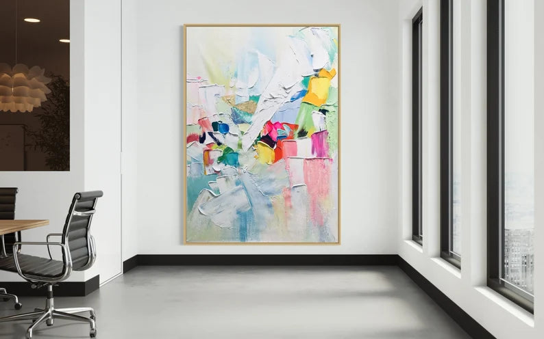Colorful abstract painting in a modern office setting with chairs and a desk.