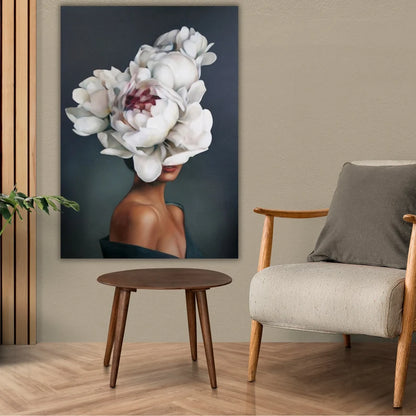 Room interior with a chair, table, and wall art featuring a floral design.