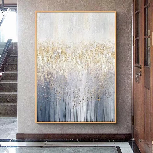 Abstract painting in a gold frame on a wall in a modern interior setting.