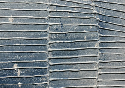 Close-up of a textured blue surface with white patches