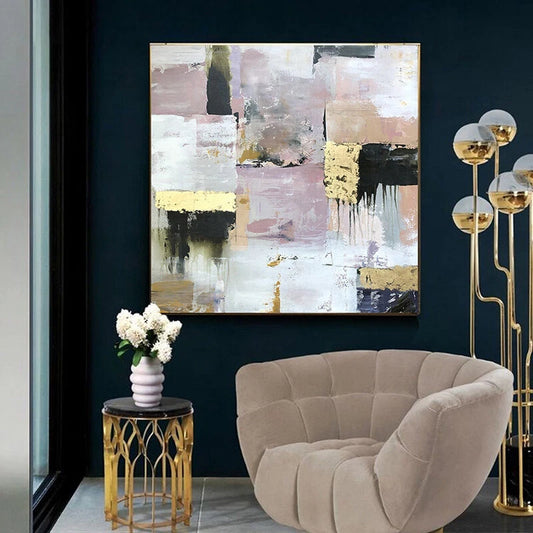 Modern interior with abstract painting, beige armchair, and decorative lamp.