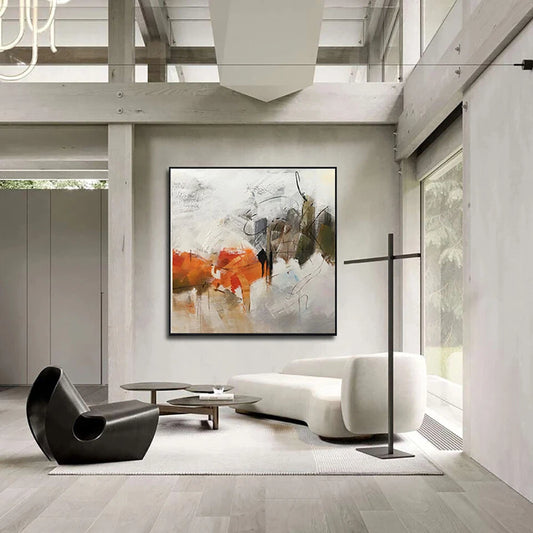 Modern living room with abstract art, minimalist furniture, and large windows.