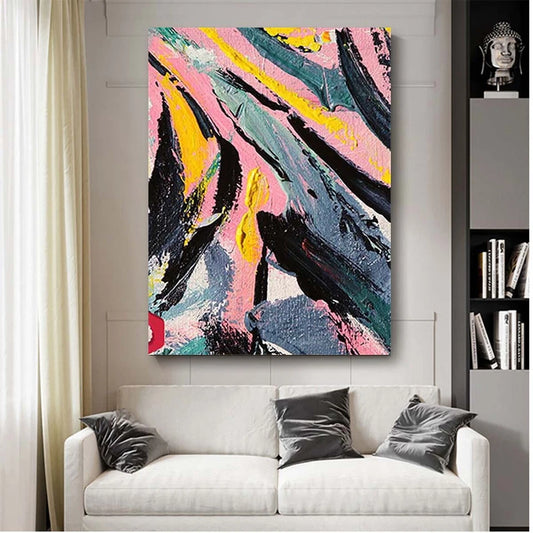 Abstract painting on a wall above a white sofa with gray pillows